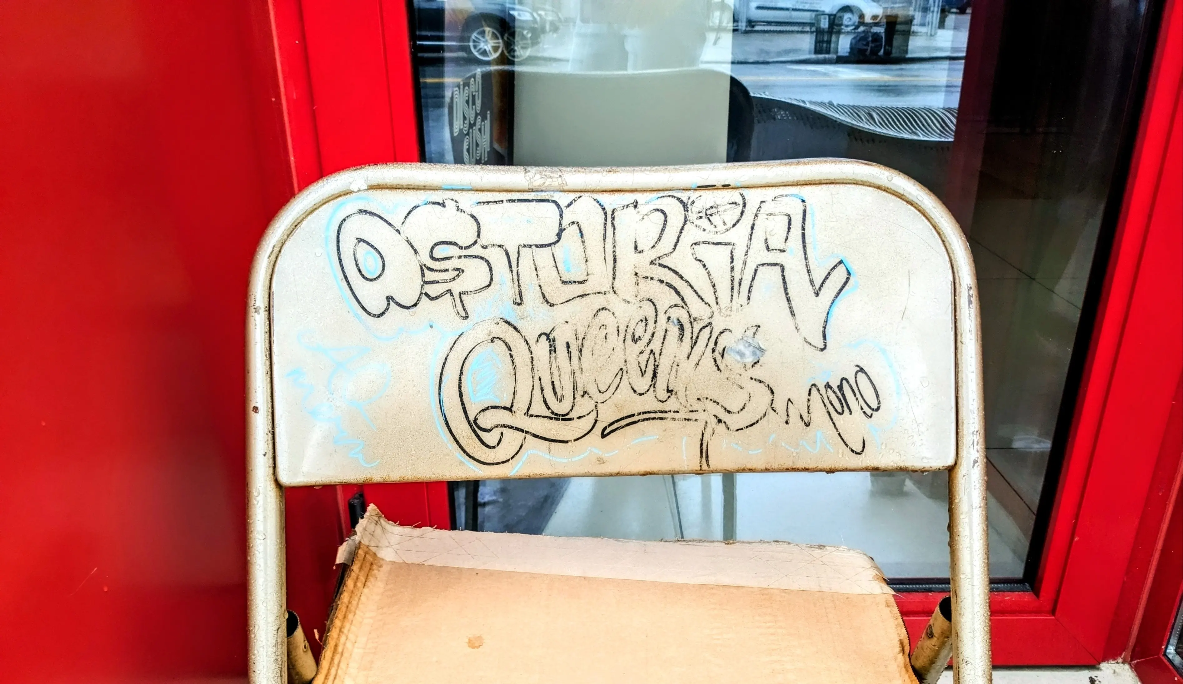 Folding char with some graffiti "Astoria Queens" 